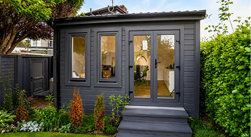 Dark grey garden building used as a beauty salon